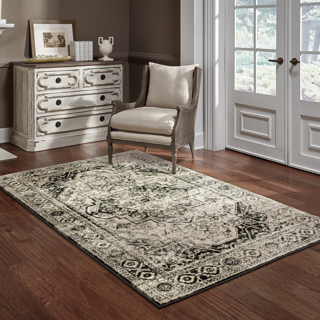 5' X 7' Black Grey Tan And Ivory Oriental Power Loom Stain Resistant Area Rug