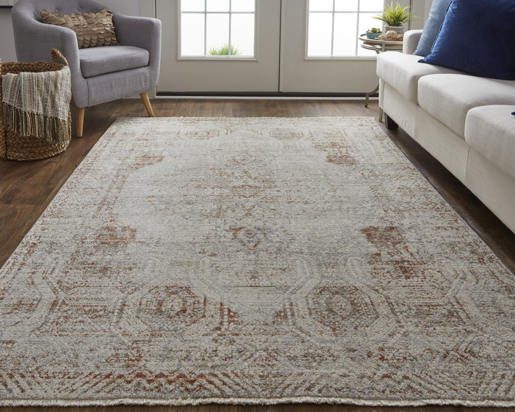 5' X 8' Tan Ivory And Orange Floral Power Loom Distressed Area Rug With Fringe